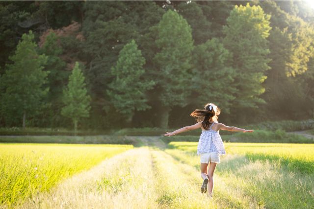 あぜ道を歩く女の子